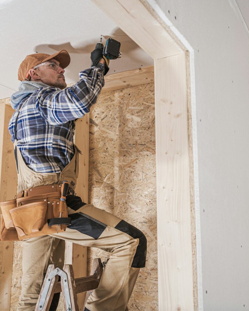 General Construction Contractor Worker Attaching Drywall Using Drill Driver